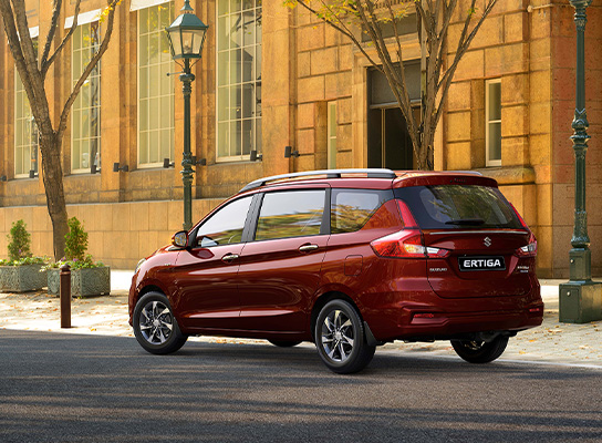Rear-shot-of-Red-Suzuki-Ertiga-parkng-nearby-a-building