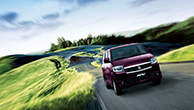 a-purple-APV-on-the-road-in-green-landscape