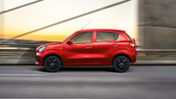 Red-Suzuki-Celerio-side-view-driving-on-a-bridge