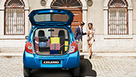 a-couple-and-a-Celerio-parked-in-front-of-a-building-with-opened-boot-and-many-gifts-in-the-laggage-space