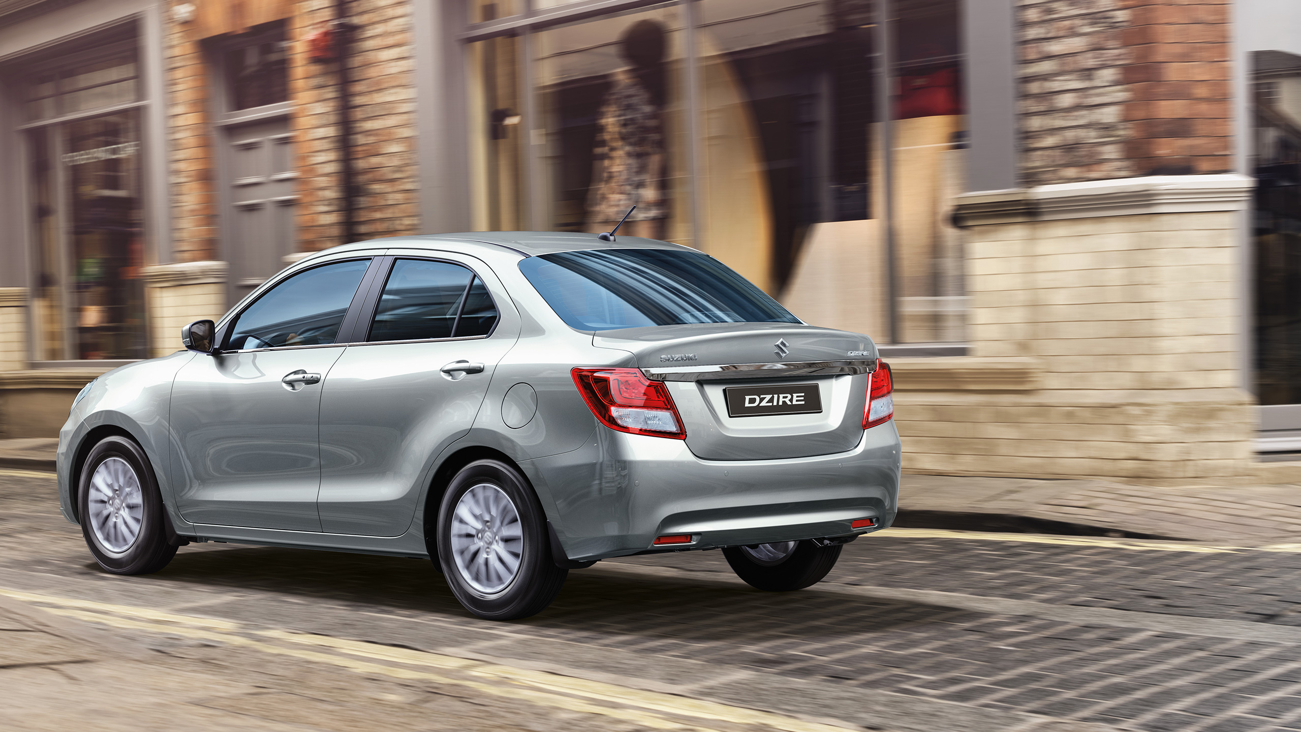 Rear-shot-of-Dzire-driving-on-narrow-street