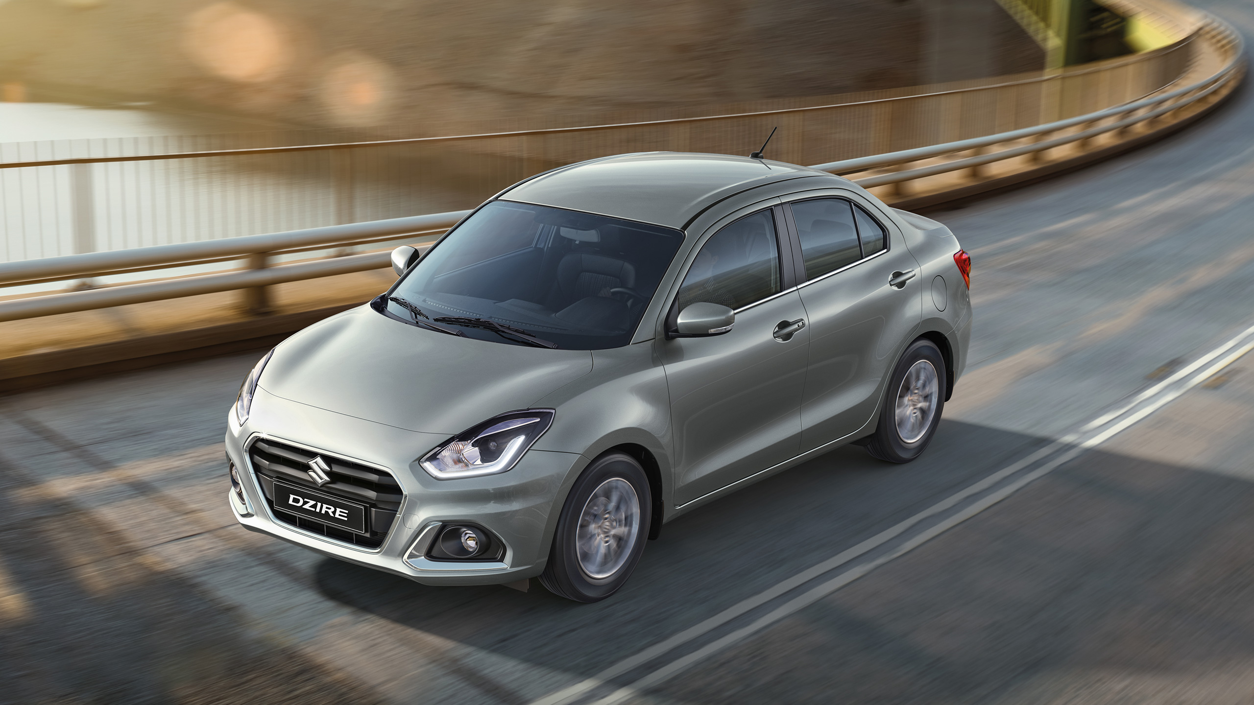 Front-shot-of-Dzire-driving-on-highway-in-suburbs