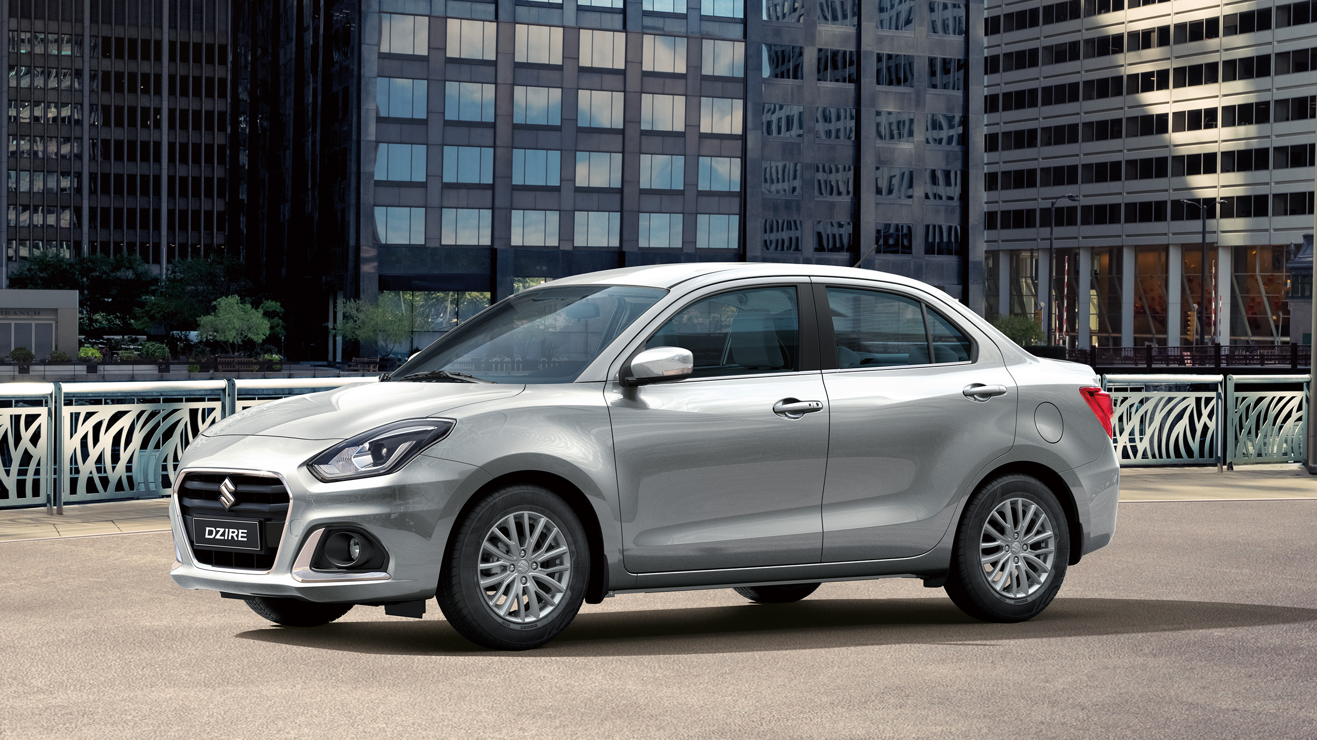 Front-shot-of-Dzire-parked-in-front-of-buildings