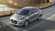 Front-shot-of-Dzire-driving-on-highway-in-suburbs