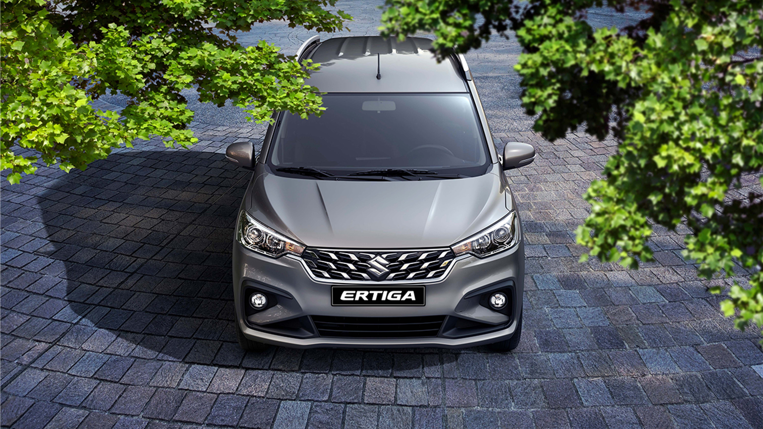 Bird-shot-of-silver-Suzuki-Ertiga-facing-this-way-from-green-leaves