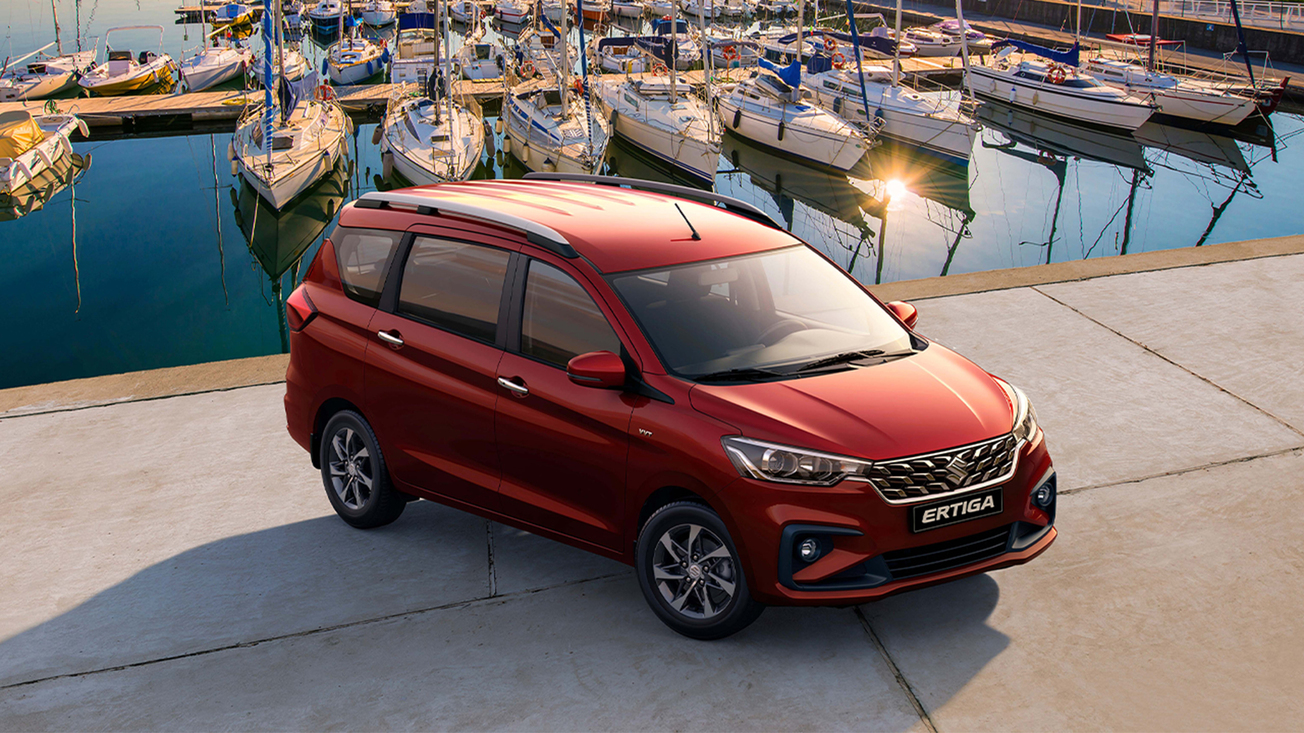 Red-Suzuki-Ertiga-parking-near-yachts