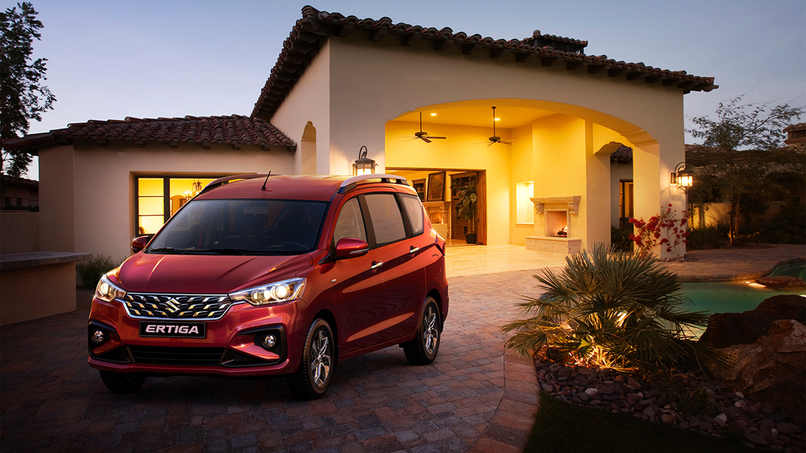 Front-shot-of-red-Suzuki-Ertiga-parking-in-front-of-a-house