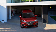 Red-Suzuki-Ertiga-departing-from-the-house