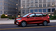 Red-Suzuki-Ertiga-driving-in-city