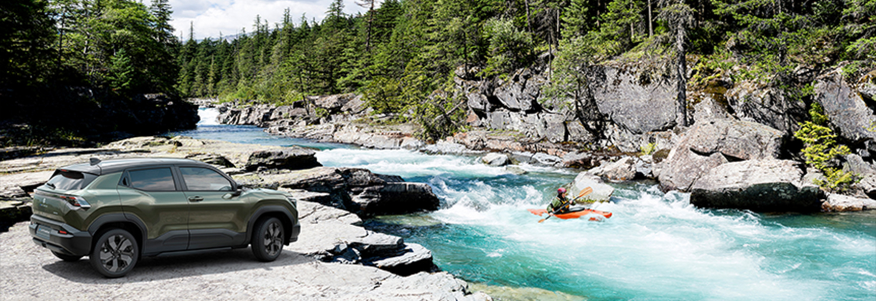 suzuki-e-vitara-parked-beside-a-river-in-a-mountain-forest-landscape-with-a-kayak-on-the-water