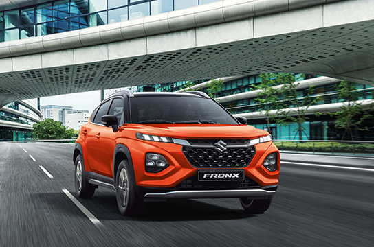 Orange-Suzuki-Fronx-running-in-a-city