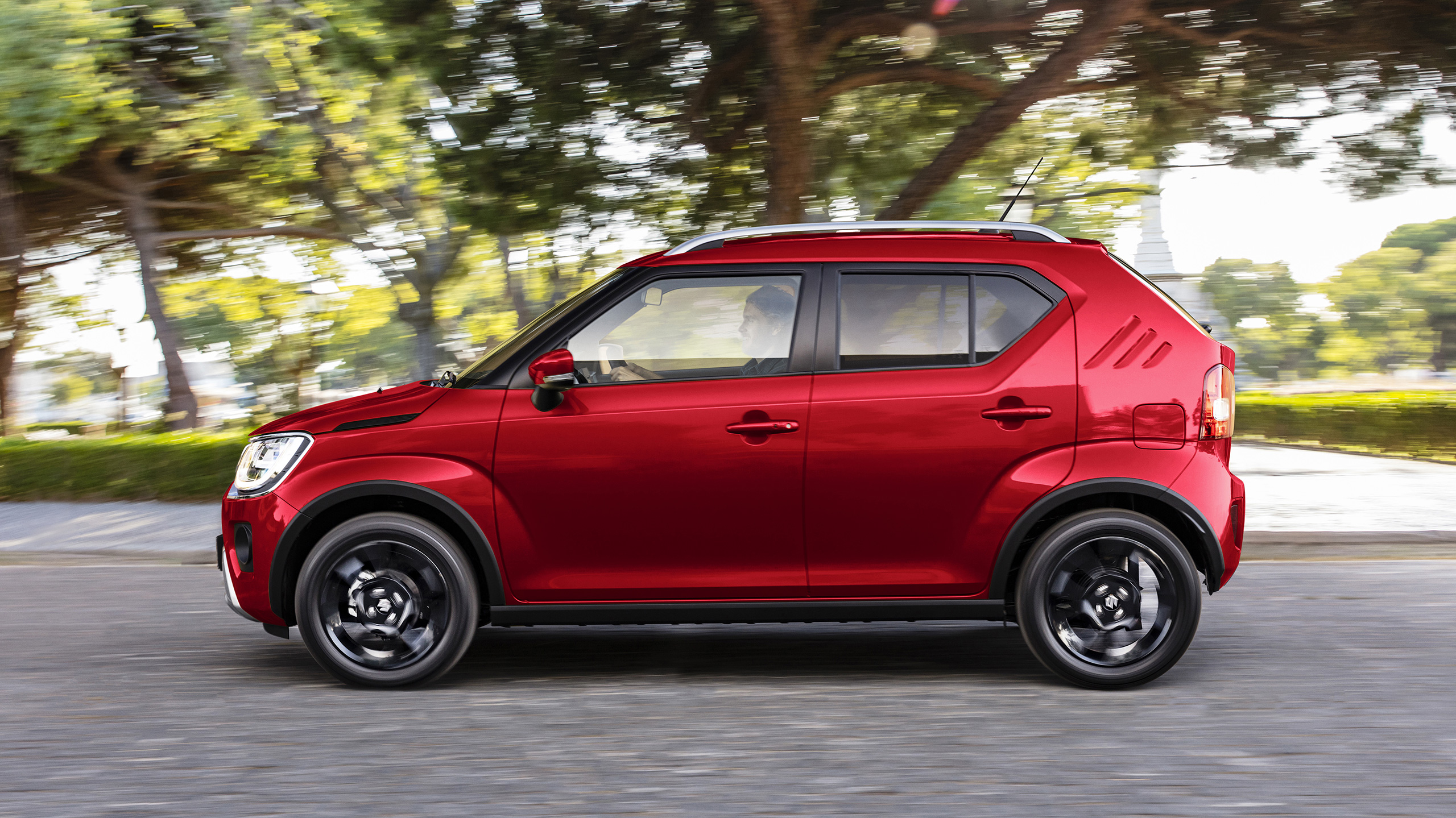 Side-shot-of-Ignis-driving-by-mountains