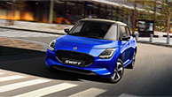 A-blue-Swift-looking-forward-is-running-through-the-city