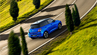 front-shot-of-red-Swift-running-straight-on-main-road