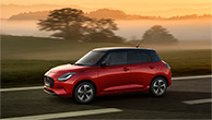 A-red-Swift-is-on-the-road-in-the-evening
