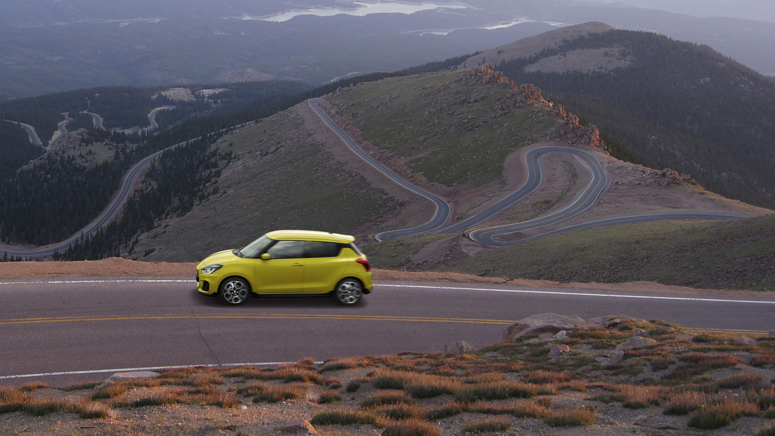 bird's-eye-shot-of-Swift-Sport-running-on-mountain-road