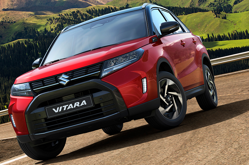A-Red-Suzuki-Vitara-running-on-a-dirt-road-in-front-of-a-mountain